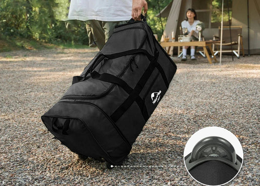 Person holding a black duffel bag with Naturehike branding, camping scene in the background.