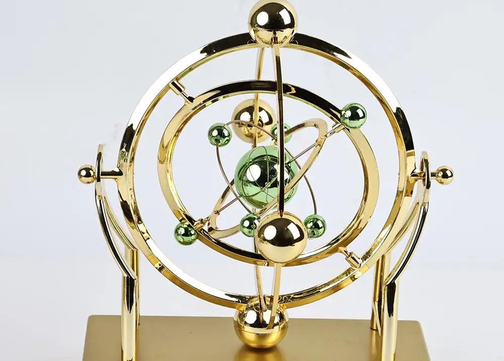 Gold and green atom model on a white background