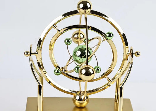 Gold and green atom model on a white background
