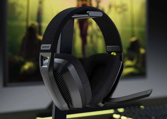 Gaming headset on a stand with a blurred gaming setup in the background
