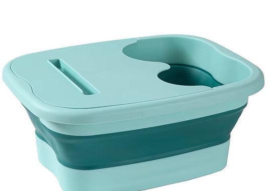 "A blue and white foldable foot bath massage bucket shown in its expanded state, featuring built-in massage rollers at the base and a sturdy carry handle. Ideal for home pedicures and portable foot soaking."