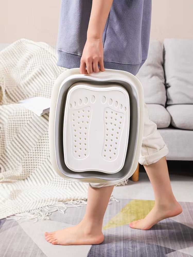 "A blue and white foldable foot bath massage bucket shown in its expanded state, featuring built-in massage rollers at the base and a sturdy carry handle. Ideal for home pedicures and portable foot soaking."