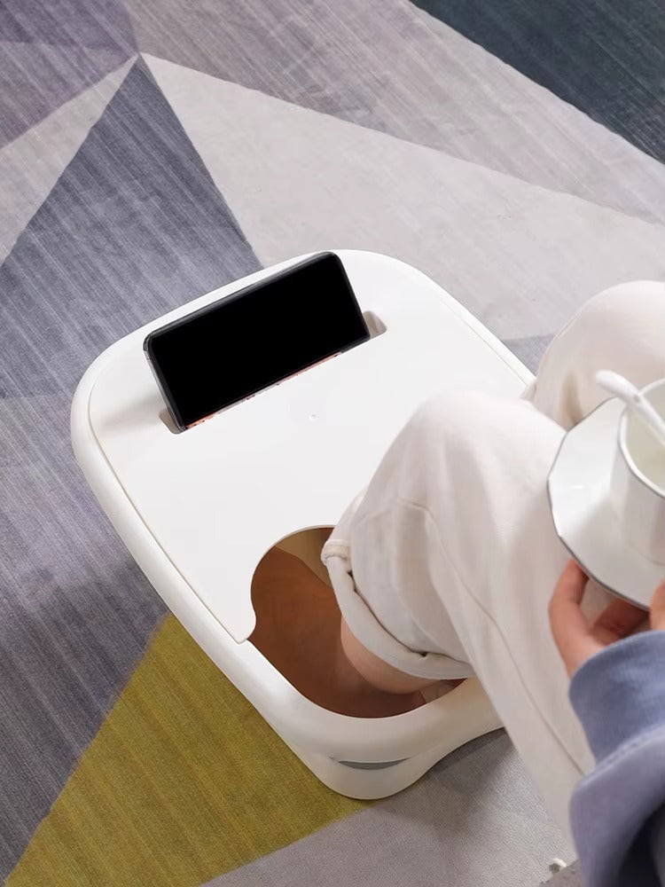 "A blue and white foldable foot bath massage bucket shown in its expanded state, featuring built-in massage rollers at the base and a sturdy carry handle. Ideal for home pedicures and portable foot soaking."
