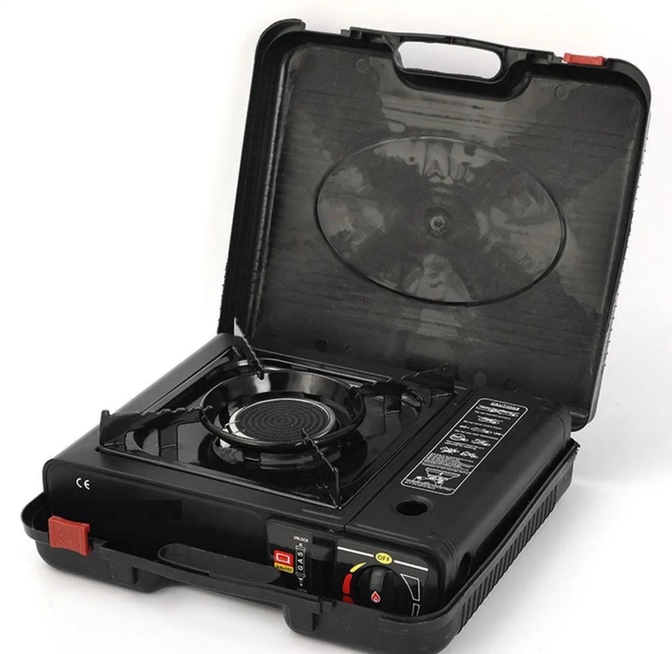 High-efficiency CORECOM outdoor stove connected to a butane canister for camping meals.