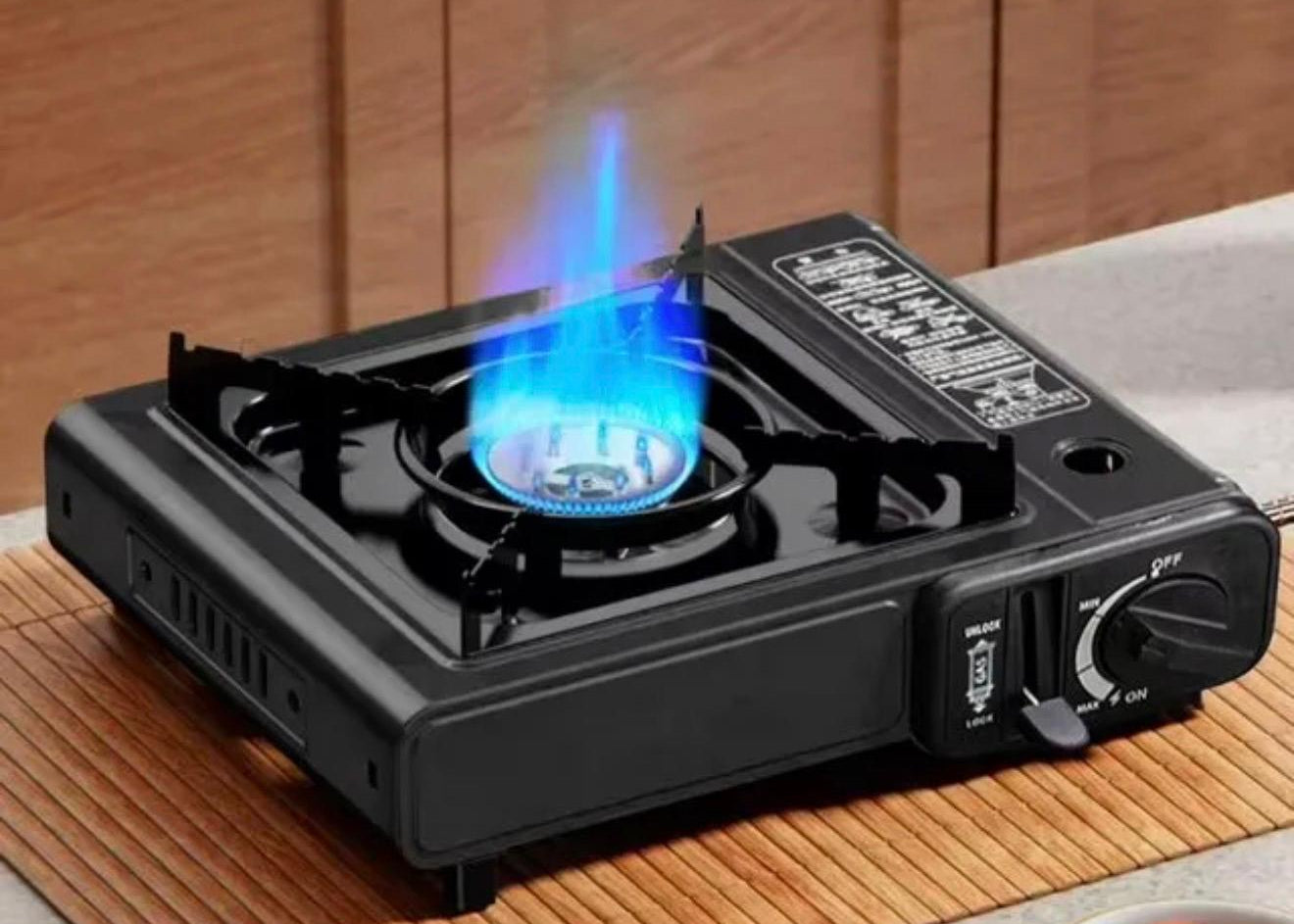 Lightweight CORECOM gas stove for hiking and backpacking, with a compact design for easy travel.